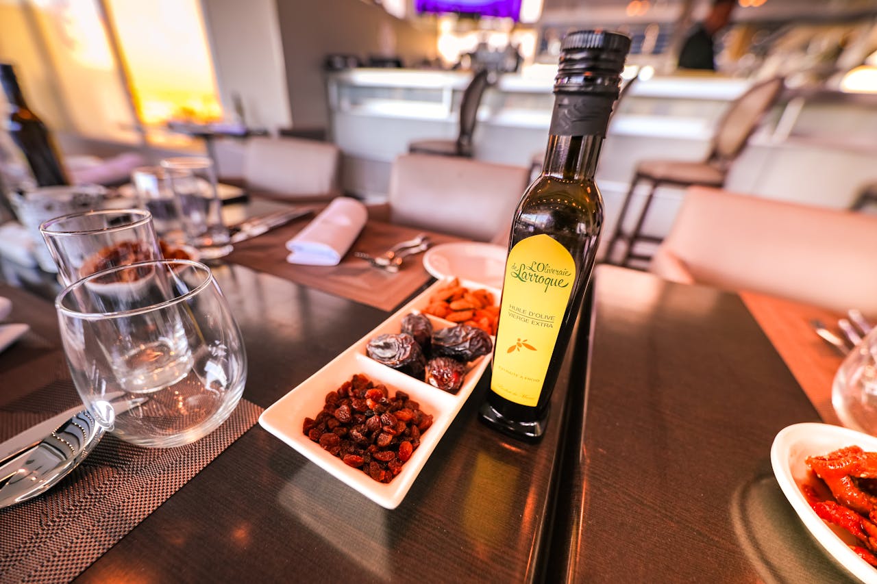 A refined dining table setting featuring olive oil and appetizers in a modern restaurant.
